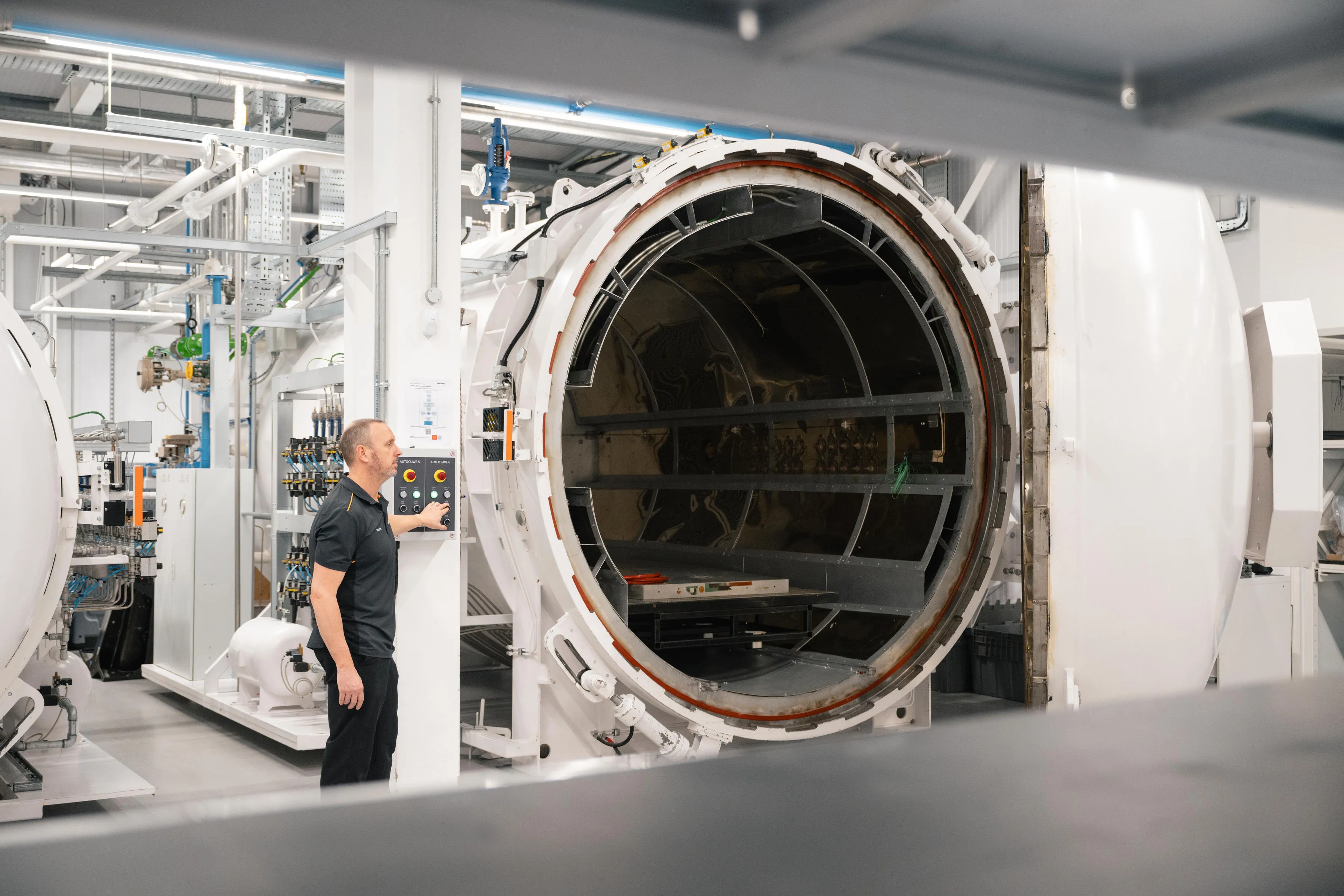 Technician at the control panel of an open autoclave in the McLaren Technology Centre