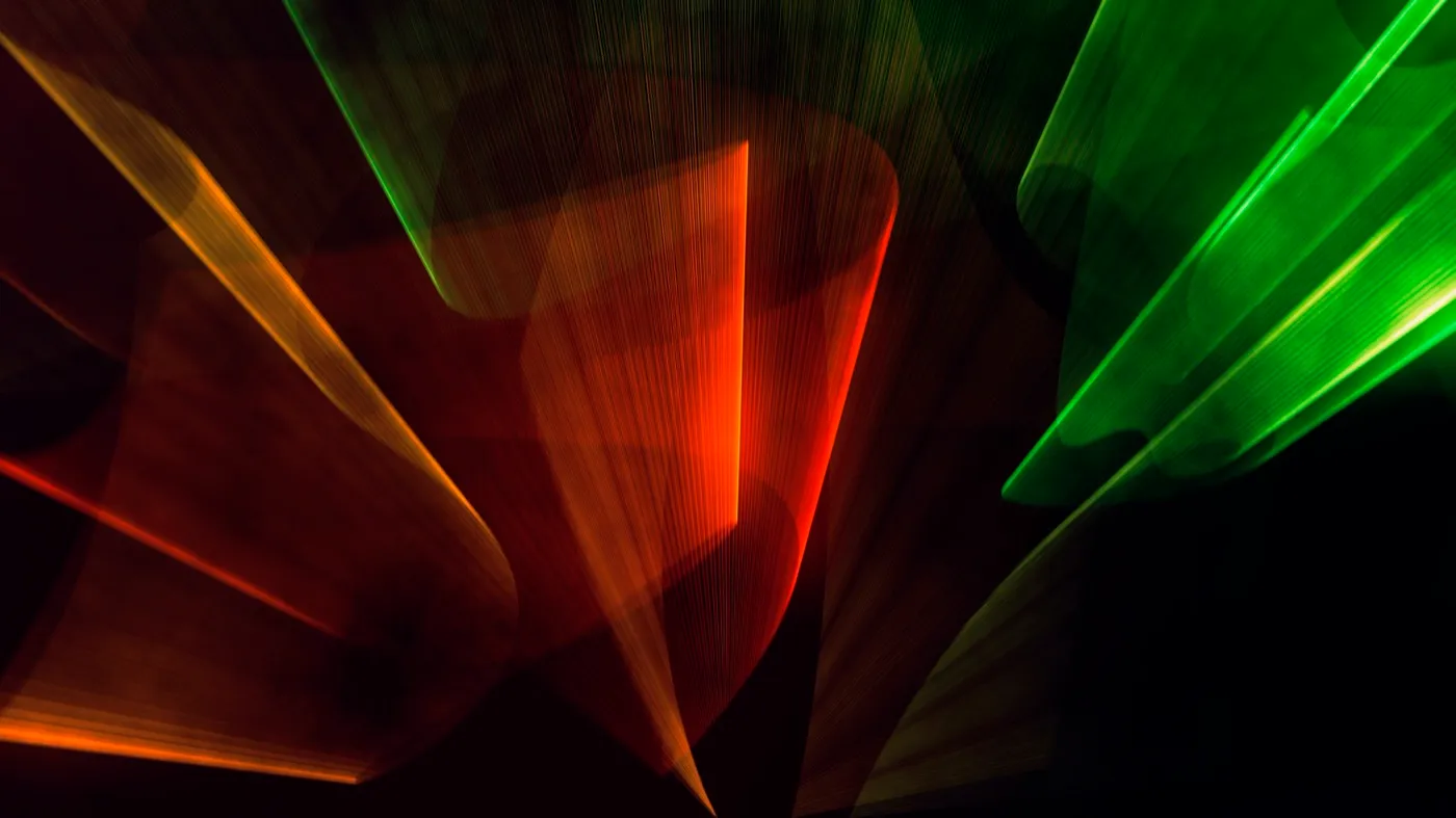 Abstract long-exposure light painting in red, orange and green planes